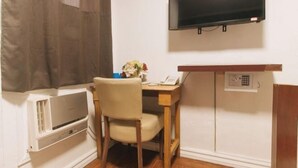 A small room with a bed, a bedside table, a TV mounted on the wall, and a window with curtains. - RedDoorz at Emperor Manila Boutique Hotel (City of Manila)