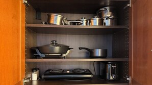 A kitchen with a stove, pots, and a coffee maker. - Lovely studio 3 Minute Walk to Miami Beach (Miami Beach)