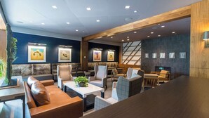 A modern interior with seating areas, tables, and artwork on the walls. - Windrose On Hudson (Ossining)
