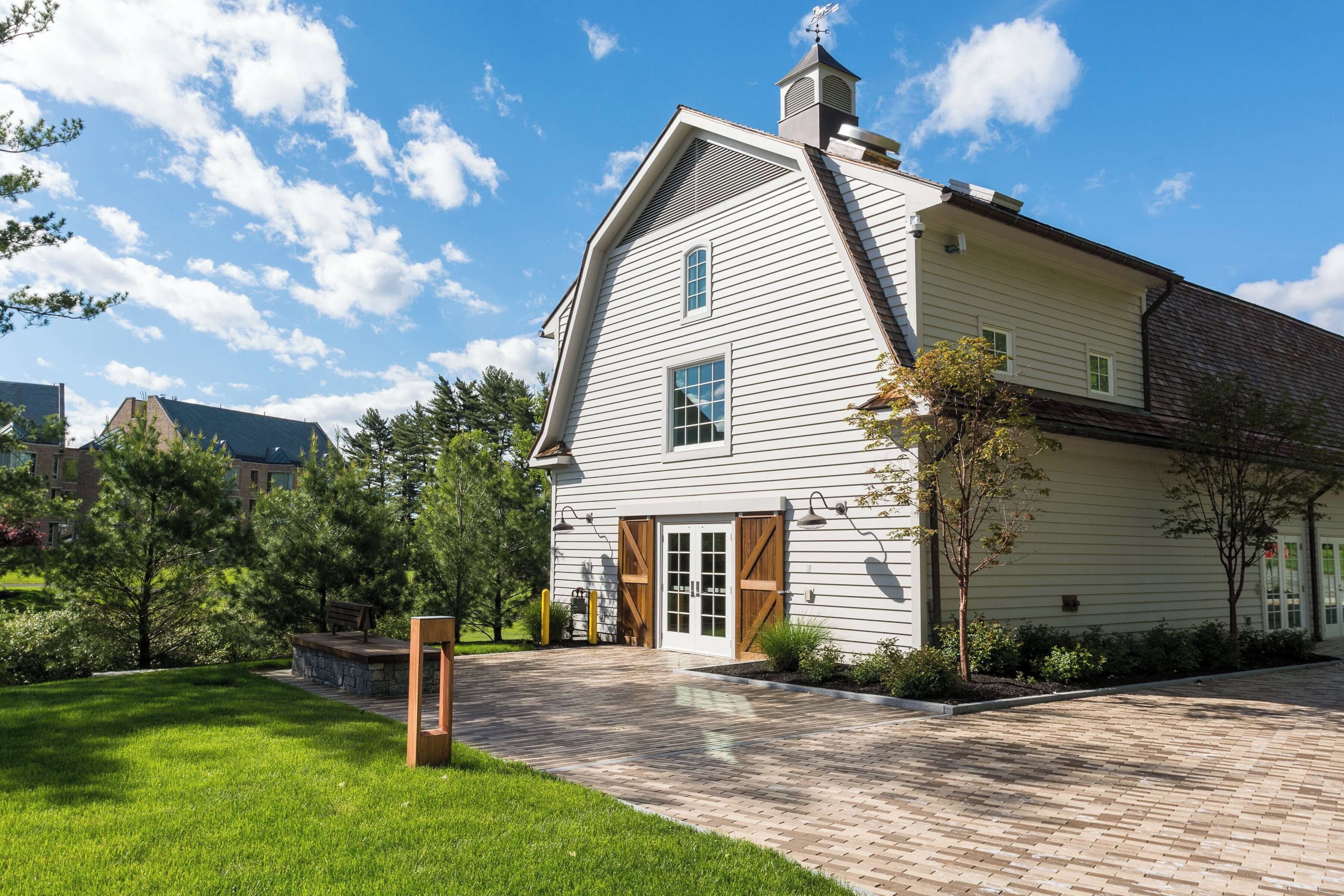 A two-story house with a gabled roof, a front porch, and a garage.