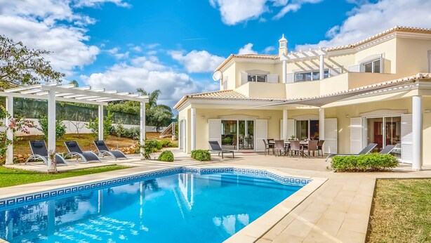 A two-story house with a swimming pool, outdoor seating, and a pergola. - Villa Larissa, luxury private villa, pool (Portimão)