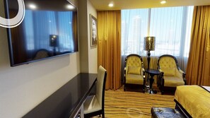 Relax in a stylish room with a flat-screen TV, comfortable bed, and cozy seating area.