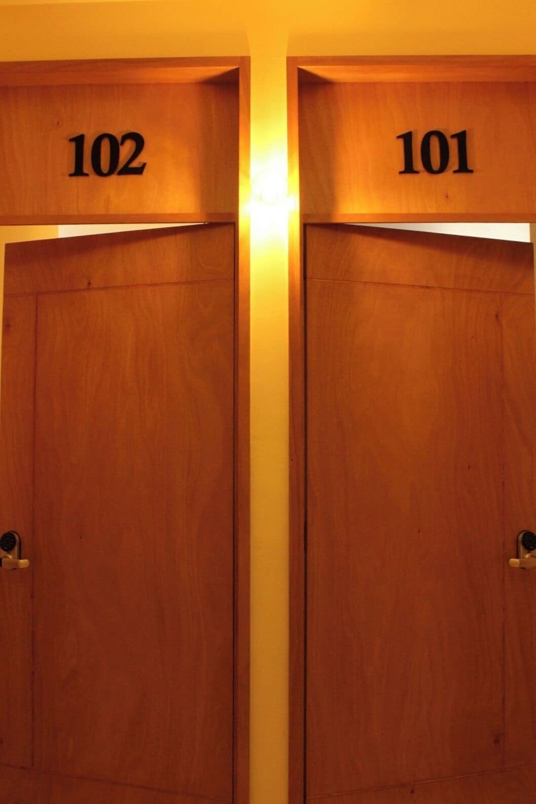 Two wooden doors with numbers 102 and 101, indicating room numbers.