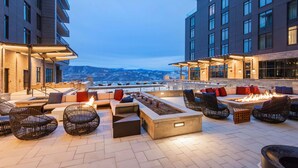 Une terrasse sur le toit avec des sièges extérieurs, un foyer et une vue sur les montagnes.