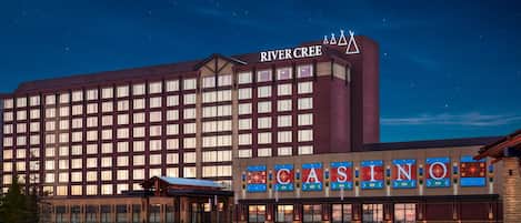 A hotel with a large building and a casino sign.
