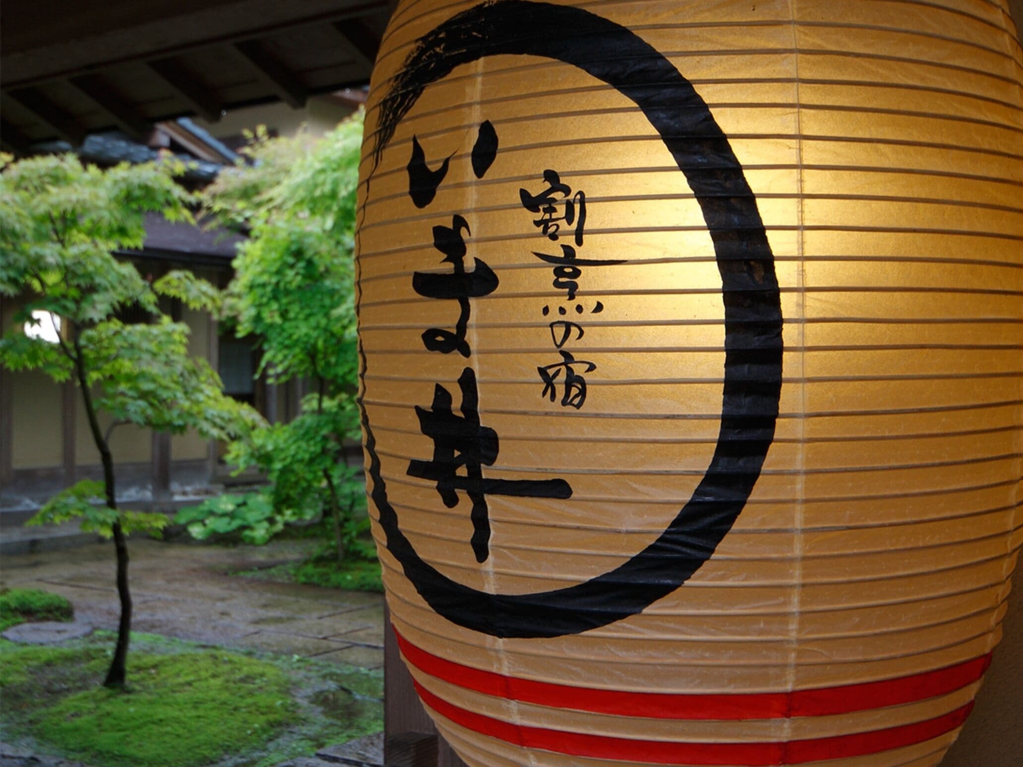 A large, cylindrical lantern with Japanese characters.