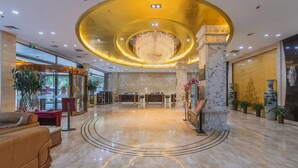 A spacious lobby with a marble floor, a large chandelier, and a reception desk. - Lidu International Hotel (Handan)
