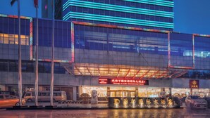 A modern hotel with a prominent sign indicating it is the International Hotel. - Lidu International Hotel (Handan)
