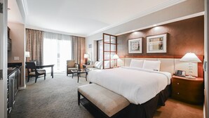 A hotel room with a large bed, a desk, a chair, a sofa, and a small table. - PH Floor Studio • Strip View • Balcony • No Resort Fee D34S2 (Las Vegas)