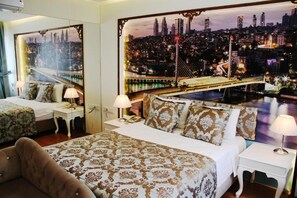 A hotel room with a large bed, two bedside tables, a nightstand, and a view of a cityscape with a bridge. - Elite Marmara Ortaköy Hotel & Suites (Istanbul)