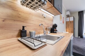 Enjoy a homey kitchenette with a coffee maker, sink, and dish rack.