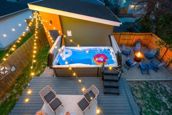 Heated Swim Spa Retreat: Dive into relaxation under string lights, perfect for unforgettable nights!