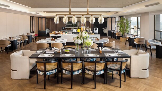 A spacious dining area with a central table set for a meal, surrounded by comfortable seating. - Mehood Lestie International Hotel Panyu Flagship Branch - Free Shuttle Bus to Canton Fair Complex During Canton Fair Period (Guangzhou)