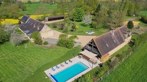 An aerial view of a property with a swimming pool, a covered patio, and a large barn-like structure. - Villa Haut Briauche (61) - Heated pool - Beach Volley - 2h Paris - 45p (Eperrais)