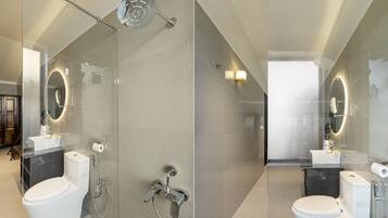 A modern bathroom with a glass-enclosed shower, a toilet, and a sink.