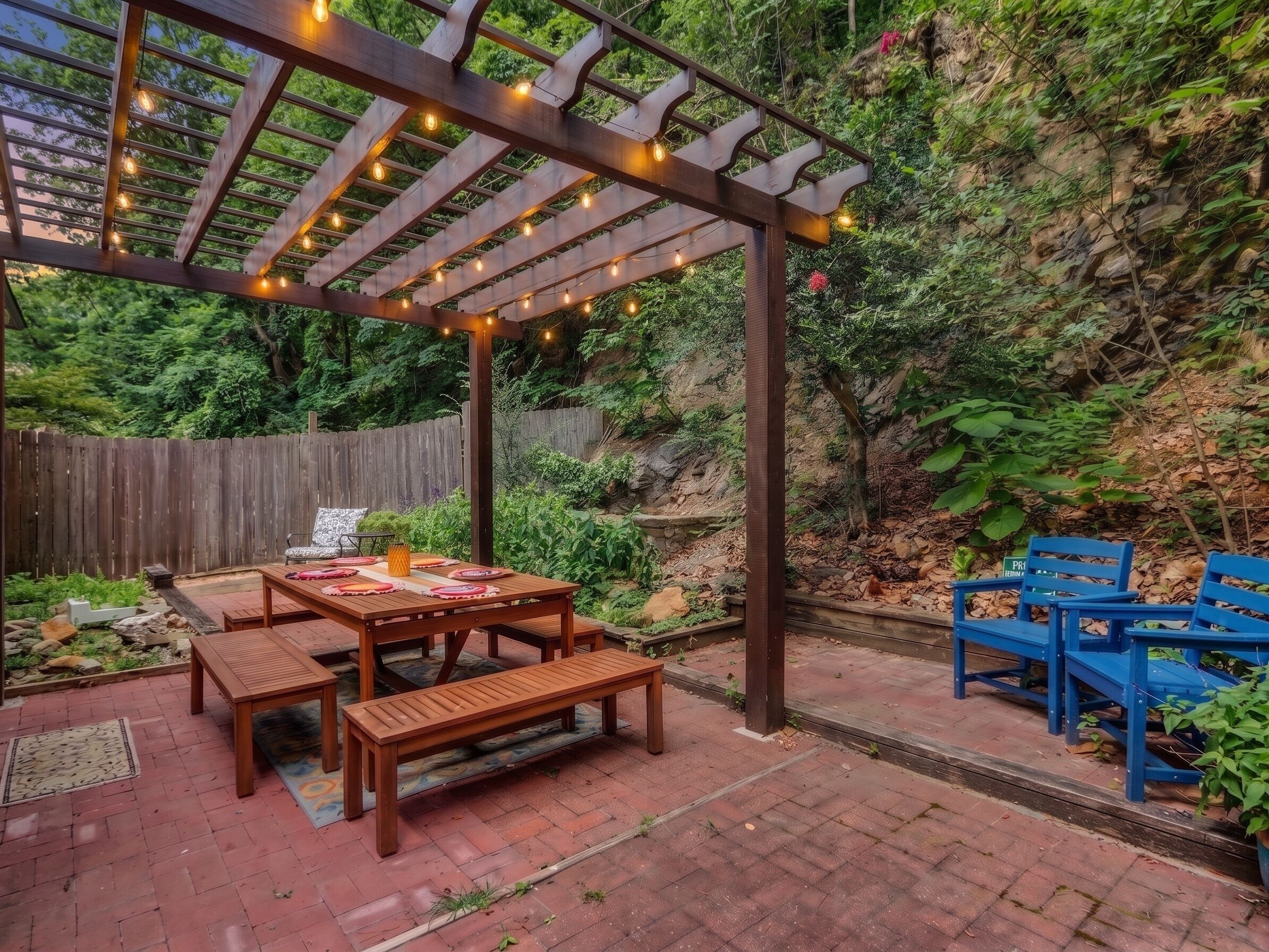 Gather beneath café lights in the private garden courtyard.