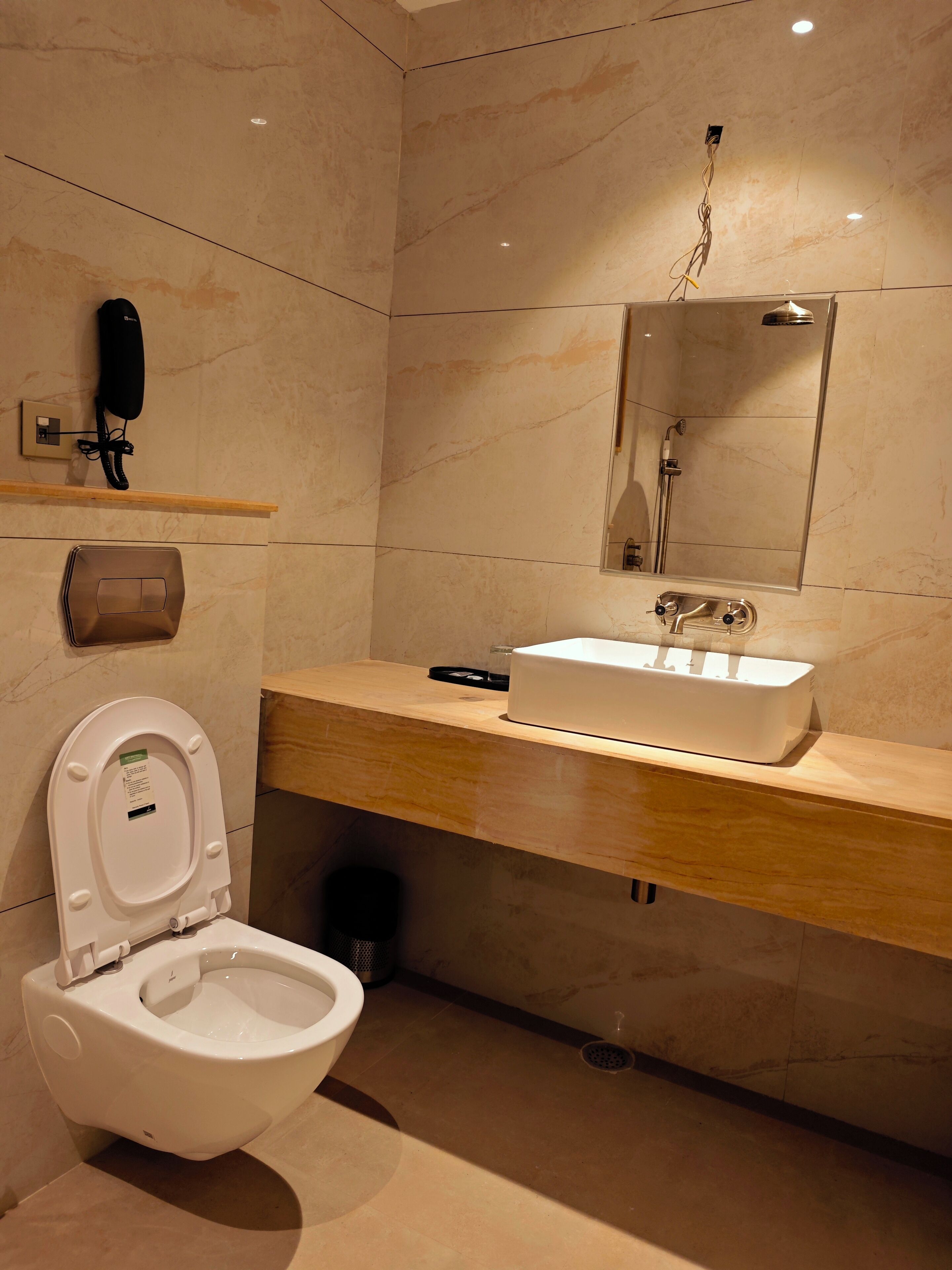 A modern bathroom with a toilet, sink, and shower.
