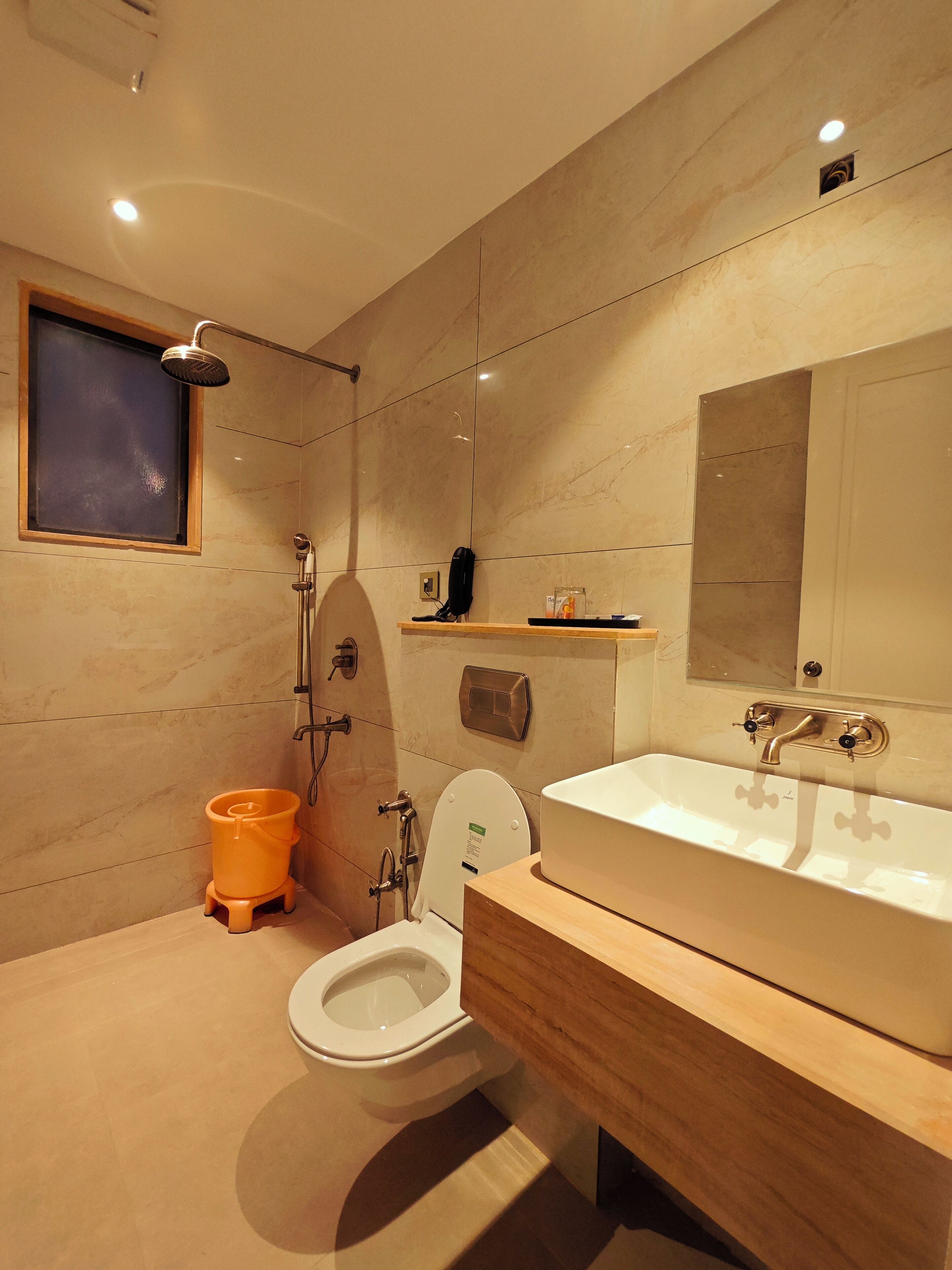 A modern bathroom with a shower, toilet, and sink.