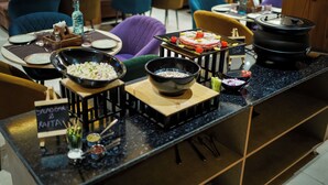 A restaurant counter with various food items and condiments, including a salad bar and a soup station. - Uno Premium Dalhousie (Dalhousie)