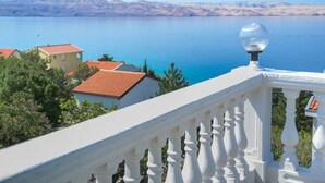 A balcony with a white balustrade overlooking a calm sea and distant mountains. - Vacation home Alma by Interhome (Karlobag)
