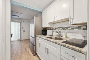 Fridge, microwave, stovetop, coffee/tea maker