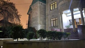 A large building with a prominent entrance, columns, and a staircase leading up to the entrance. - Ekm Hotel (Baku)