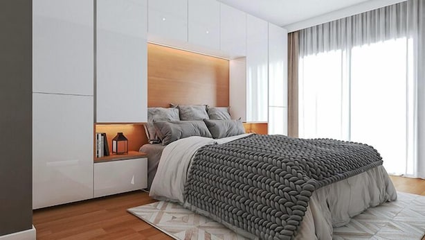 A modern bedroom with a large bed, built-in storage, and a view of the outdoors. - Ekm Hotel (Baku)