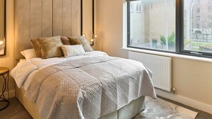 A bedroom with a bed, a window, and a radiator. - Host Stay Chic Townhouse by the Docks (Liverpool)