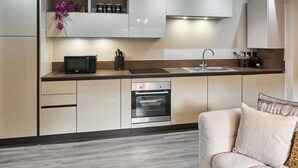 A modern kitchen with built-in appliances, a sink, and a countertop. - Host Stay Chic Townhouse by the Docks (Liverpool)