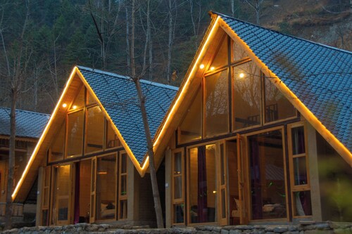 Riverside wooden cottages with a great valley-scape
