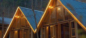 Riverside wooden cottages with a great valley-scape