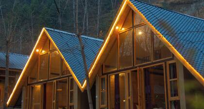 Riverside wooden cottages with a great valley-scape