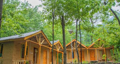 Riverside wooden cottages with a great valley-scape