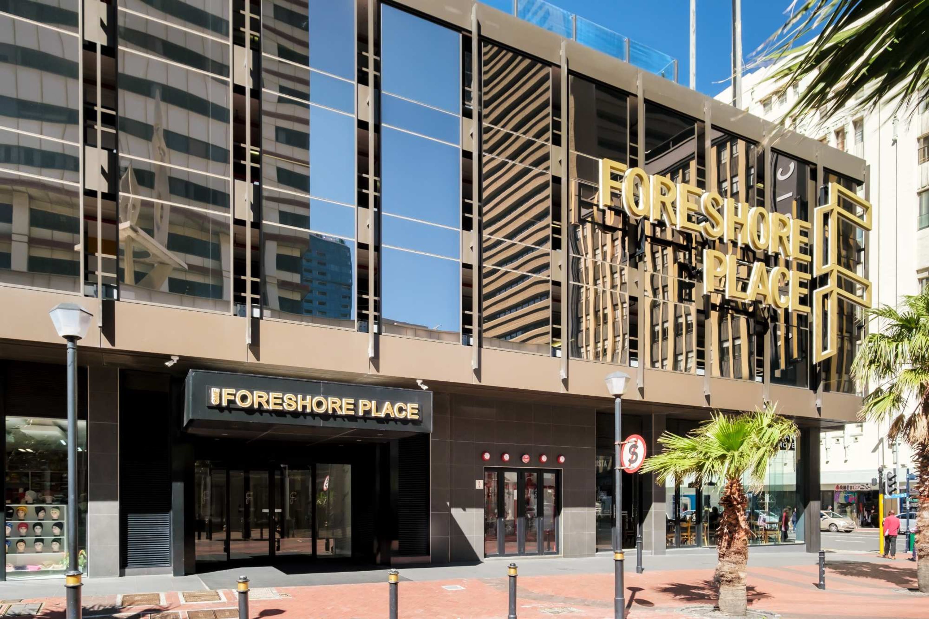 A modern building with a prominent sign reading "FORESHORE PLACE".