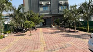 A hotel with a tiled entrance and a sign in a foreign language. - Shri Nath Hotel And Lodging (Gangapur)