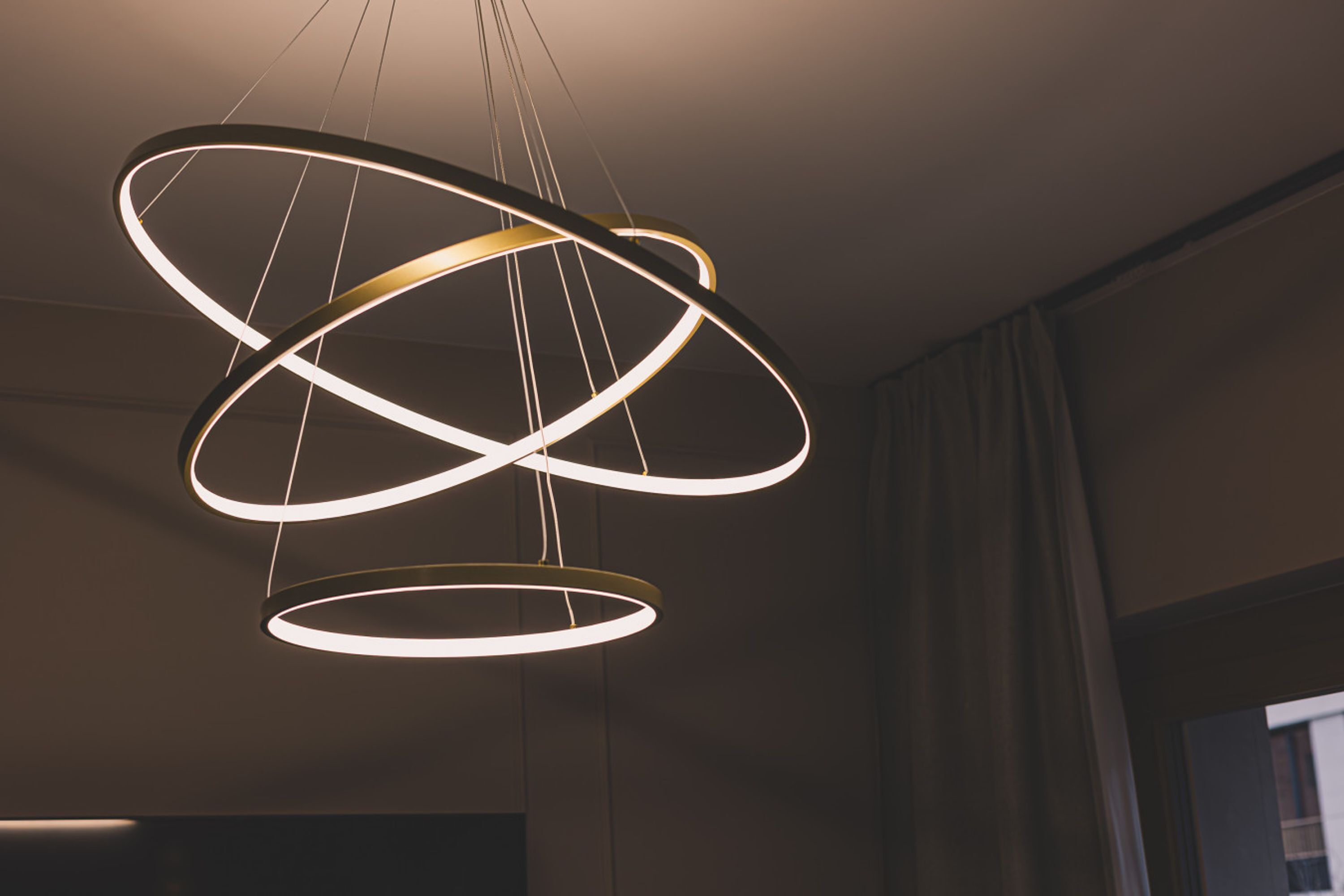 A modern chandelier with multiple circular light fixtures suspended from the ceiling.