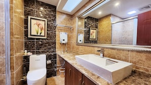 A modern bathroom with a large sink, toilet, and a framed picture on the wall. - Zhu Youjia Homestay (Chongqing)