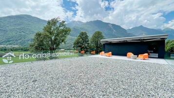 A building with outdoor seating and a view of mountains.