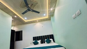Une chambre à coucher avec un lit, un ventilateur de plafond et une fenêtre.