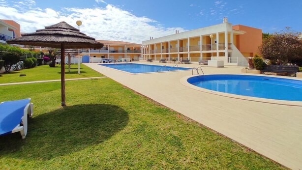 A hotel with a swimming pool, a covered area, and a building with balconies. - Apartment Josefa Summ (Vale de Parra)
