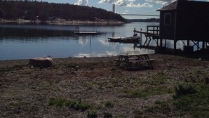 A lakeside cabin with a dock and a picnic table. - Cozy Holiday Home for 2 in Stenungsund (Stenungsund)