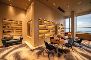 Enjoy a city view from the large window, relax in the seating area with a sofa and chairs, and make use of the shelving units.