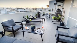A rooftop terrace with seating, a grill, and a hanging chair. - D Pool Top (L-Imsida)