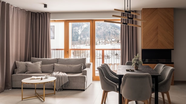 A modern living room with a sofa, coffee table, and dining area. - Tarasowa Polana (Koscielisko)