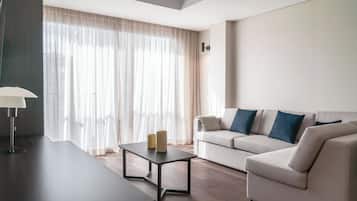 A modern living room with a sofa, a coffee table, and a lamp.
