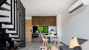 A modern apartment with a kitchen, dining area, and living space.