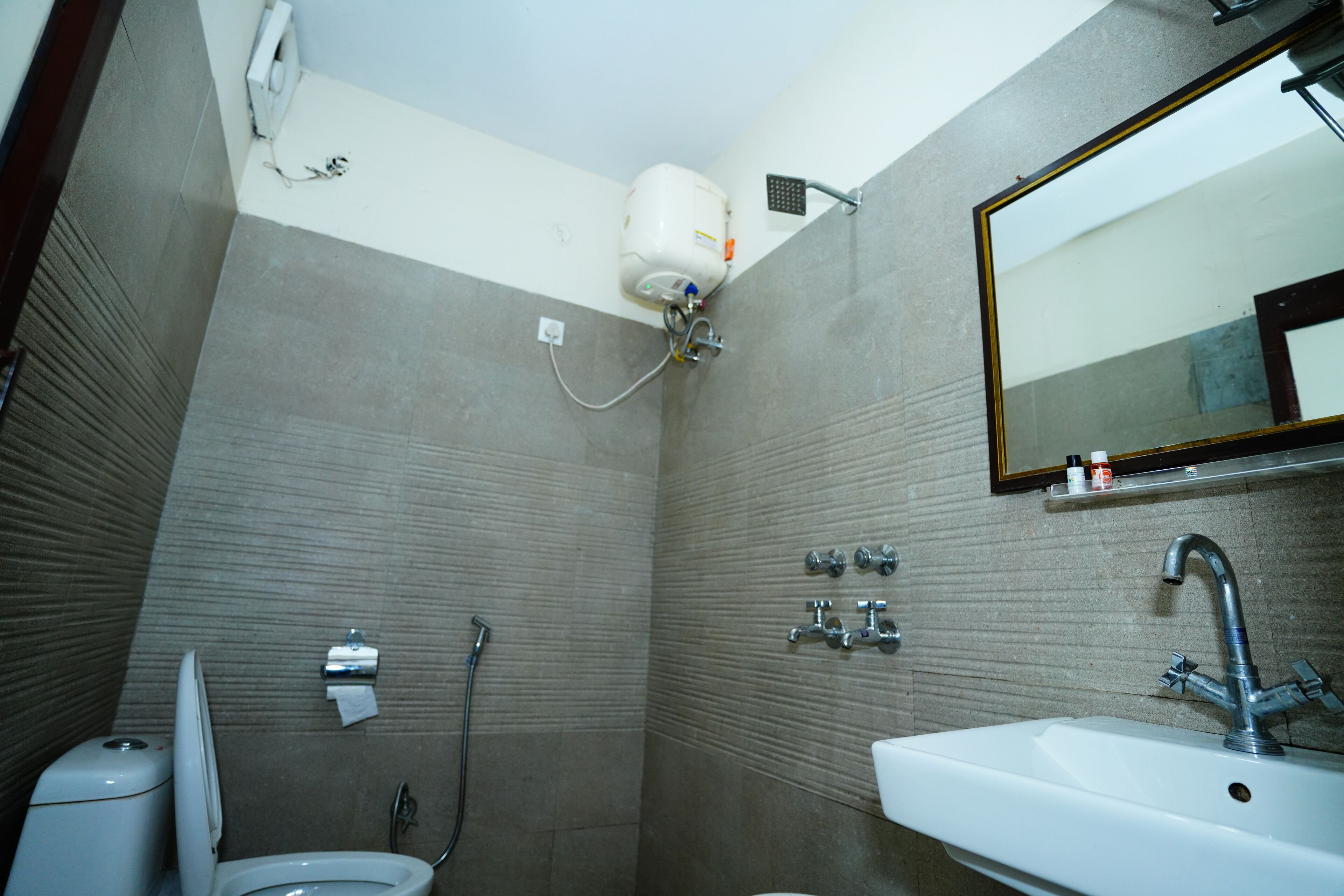 A bathroom with a toilet, sink, and shower.