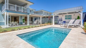 A two-story house with a swimming pool, outdoor seating, and a covered patio area. - Eastport - Luxury Beach Retreat with Plunge Pool (Catherine Hill Bay)