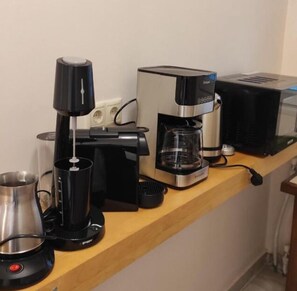 Fully equipped kitchen with a coffee maker, toaster, and kettle.