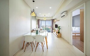 Family Suite, Multiple Bedrooms, Pool Access, City View | Living area | 65-inch Smart TV with cable channels, Netflix, smart speakers - Emily Residence Tan Son Nhat Airport (Ho Chi Minh City)